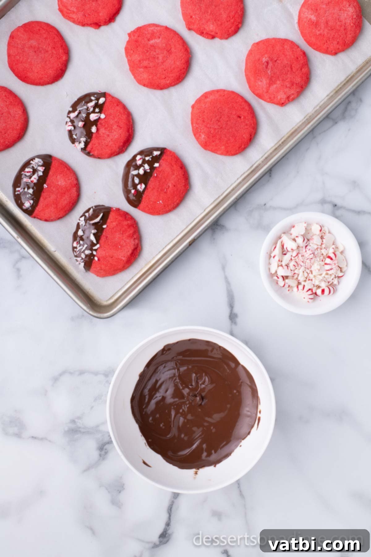 Dipped Peppermint Chocolate Delights 12 Cookies dipped in chocolate and placed on baking sheet. Dipping cookies in melted chocolate.