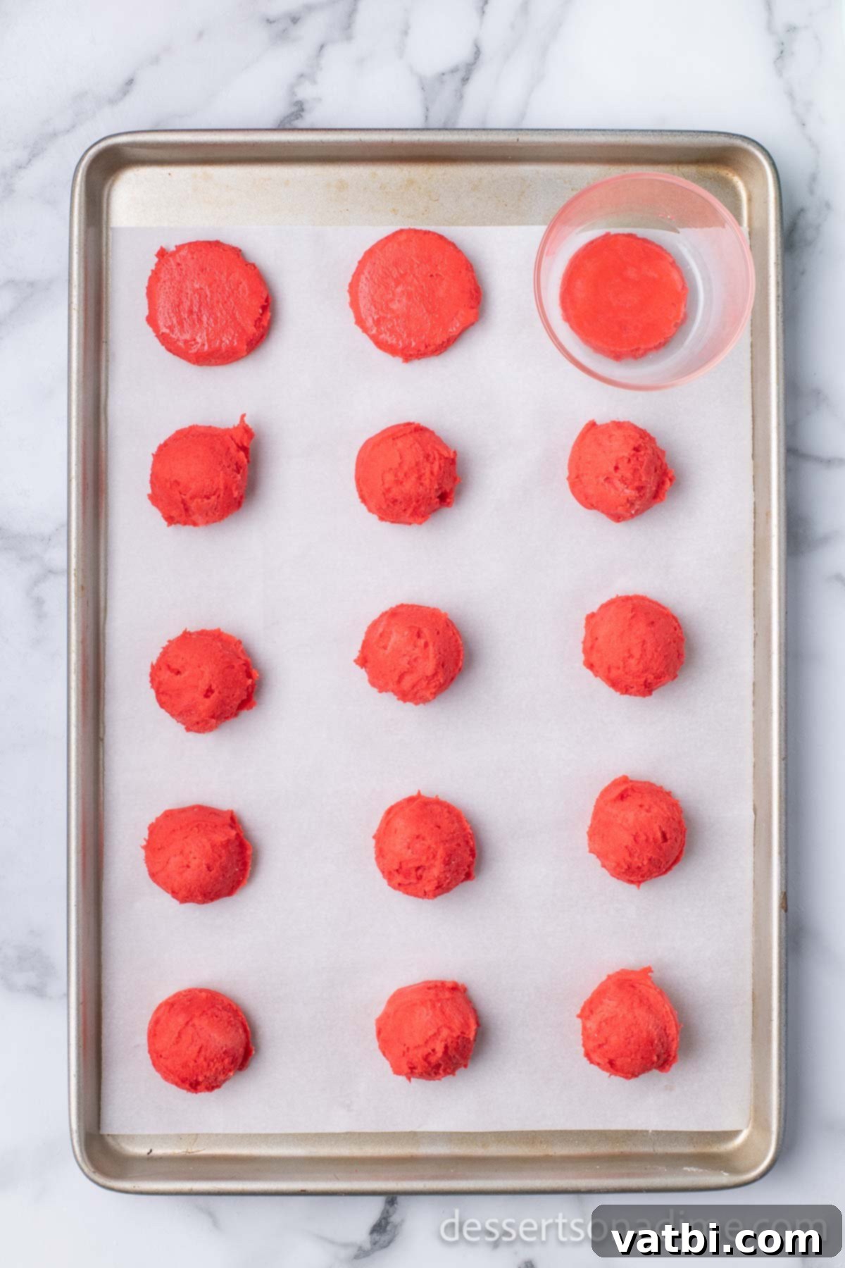 Dipped Peppermint Chocolate Delights 8 Cup pressing down each cookie. Flattening cookie dough balls.