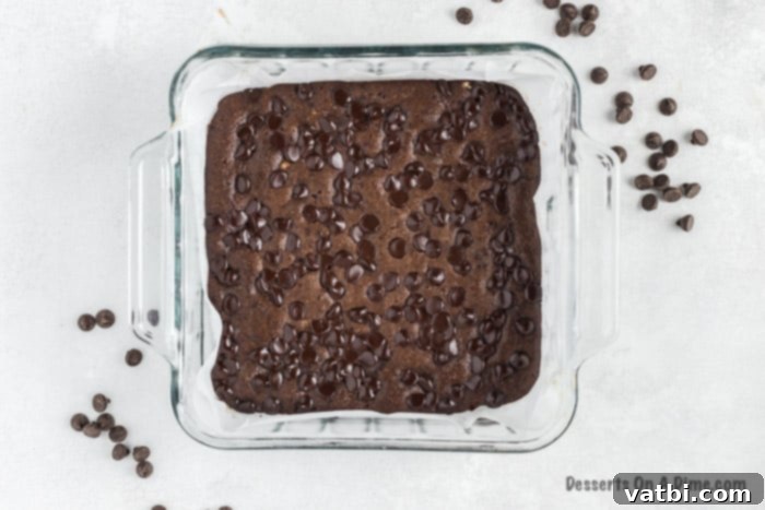 Decadent Keto Brownies 3 Brownie batter poured into a parchment-lined baking dish.