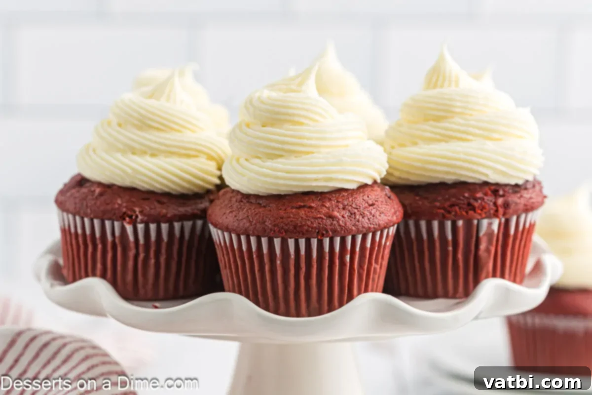 Red velvet cupcakes arranged on a platter, showcasing their vibrant color and creamy frosting.