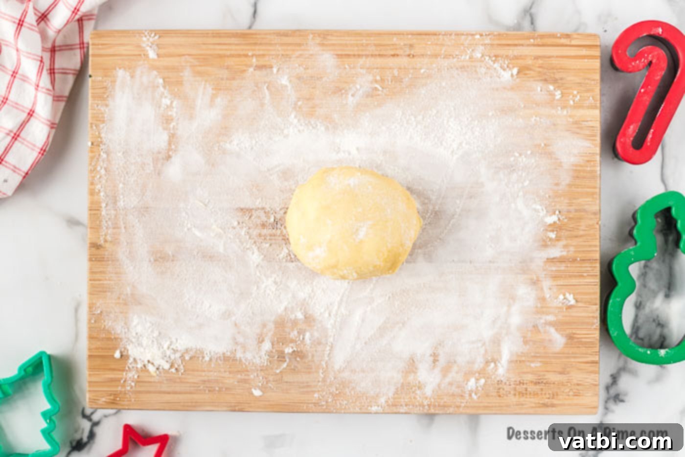 Festive Christmas Cut-Out Sugar Cookies 4 Cookie dough on a floured surface, ready for rolling.