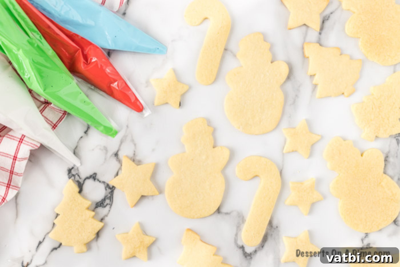Festive Christmas Cut-Out Sugar Cookies 9 Icing in piping bags with different colors, ready to decorate.