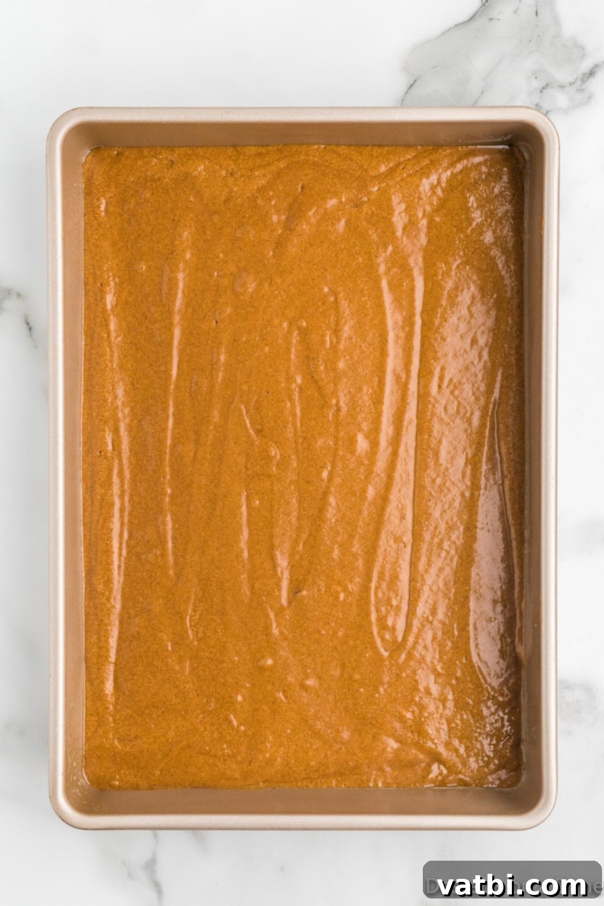 Spiced Molasses Delight 5 Pouring gingerbread cake batter into the prepared cake pan