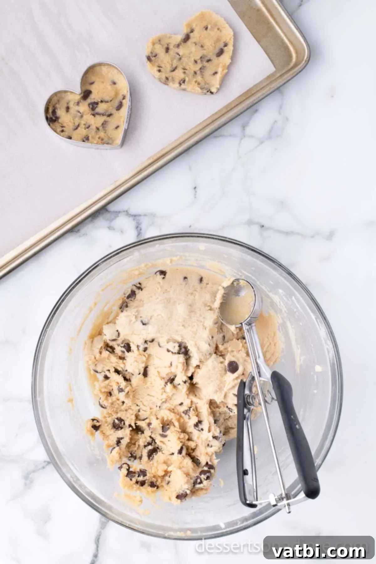 Love-Filled Chocolate Chip Hearts 8 Cookie dough scooped into 1-inch balls and then shaped into hearts using a cookie cutter on a baking sheet.