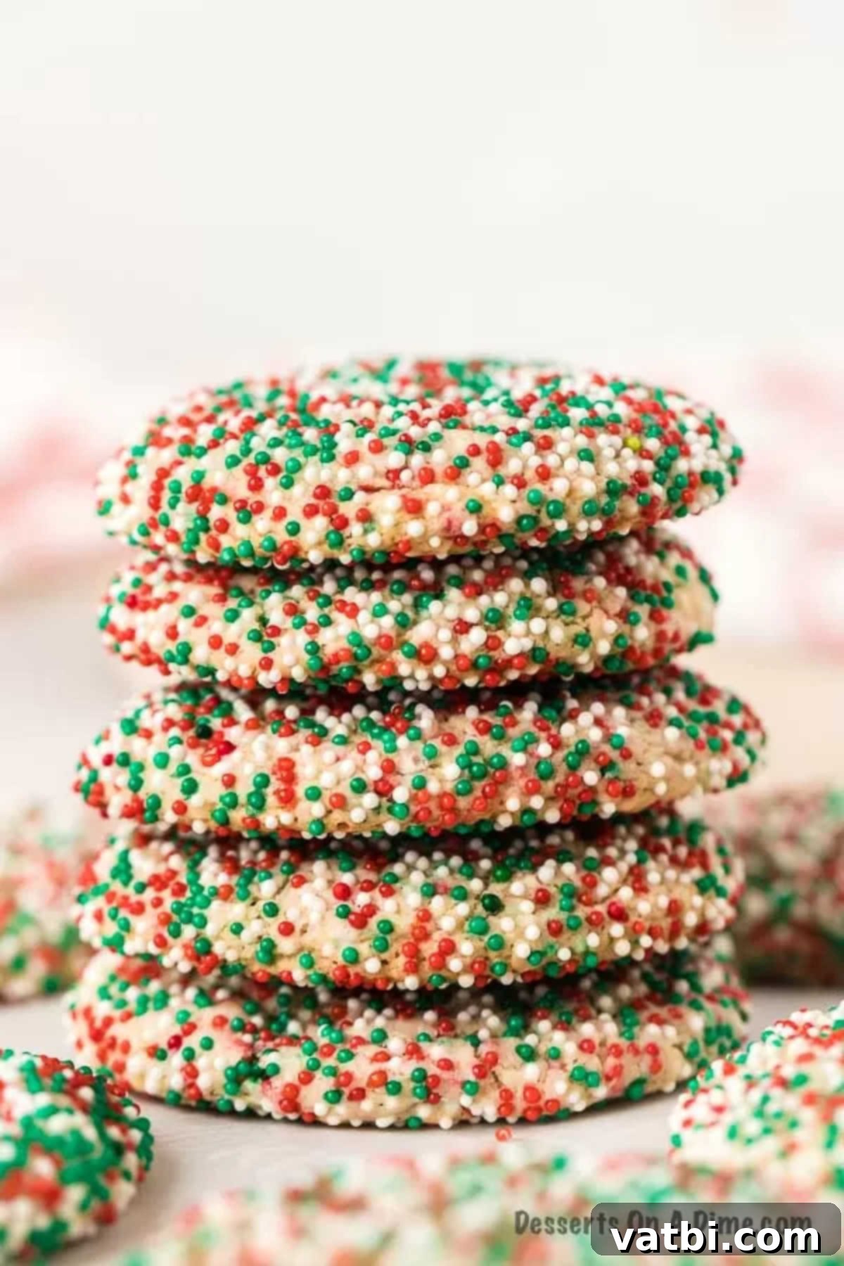 Christmas cake mix cookies make an easy and festive treat with only 4 ingredients. They are so light and fluffy for the perfect dessert. Learn how to make cake mix cookies with sprinkles. This is the best treat. #dessertonadime #ChristmasCakeMixCookies #Recipeseasy4ingredients #xmas #christmascakemixcookieseasy #recipes Christmas Cake Mix Cookies stacked, covered in red and green sprinkles
