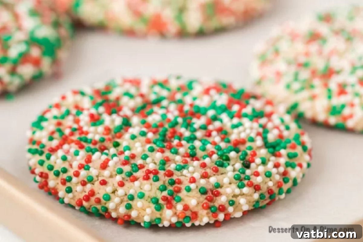 Festive Cake Mix Cookie Delights 5 Freshly baked cookies cooling on a baking sheet.