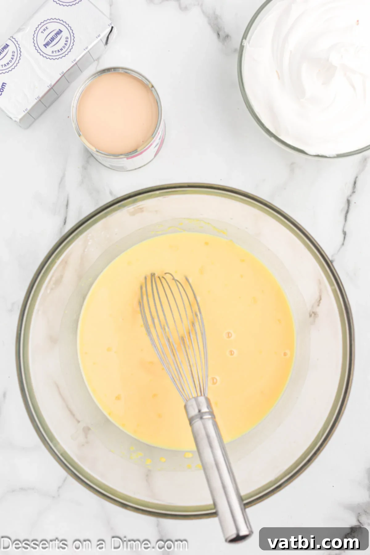 Instant French vanilla pudding mix and milk combined in a large mixing bowl.