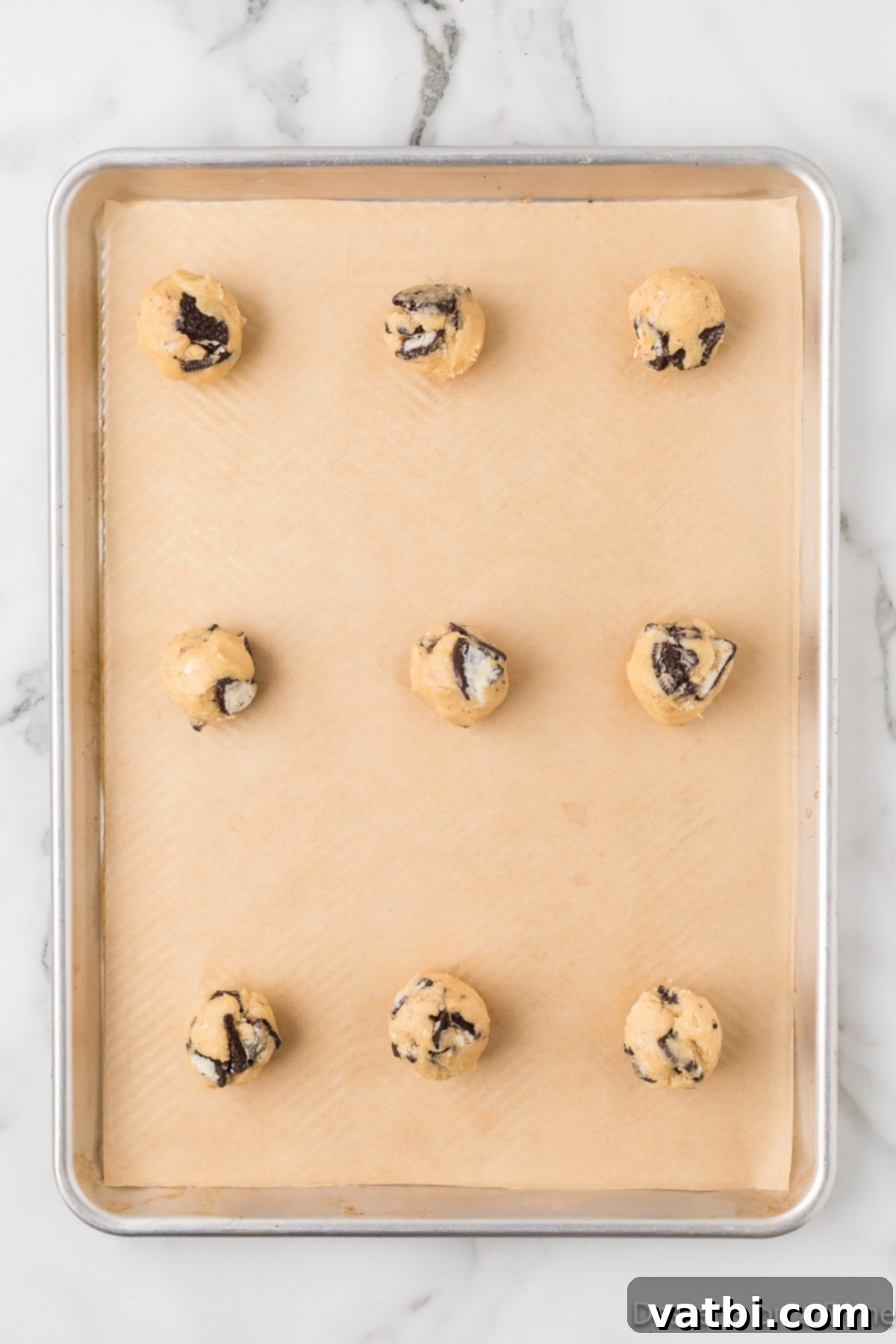 Cookies & Cream Bliss 7 Cookies formed into balls and placed on baking sheet.