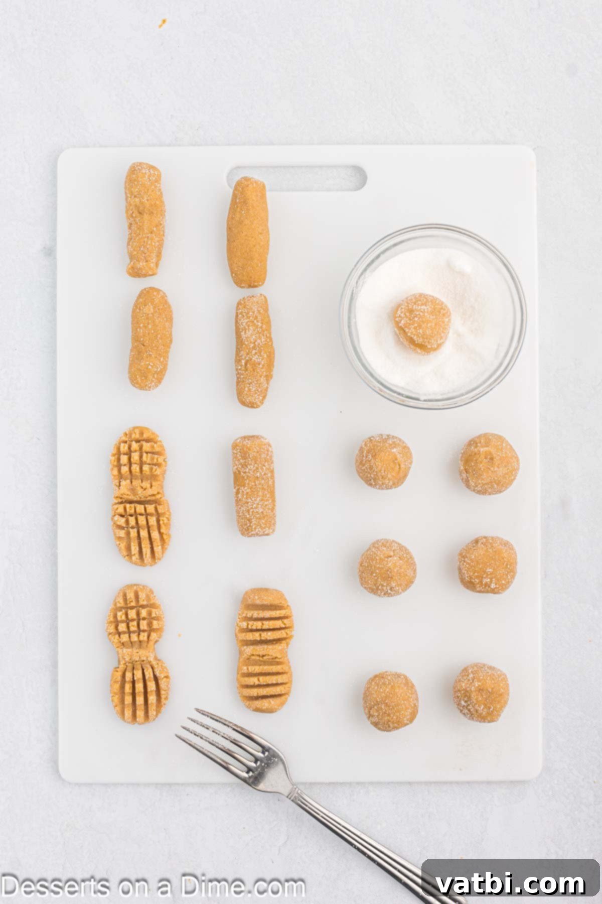 Golden Peanut Perfection 6 Cookie dough rolled into balls and coated in sugar. Then shaped into peanut shapes.