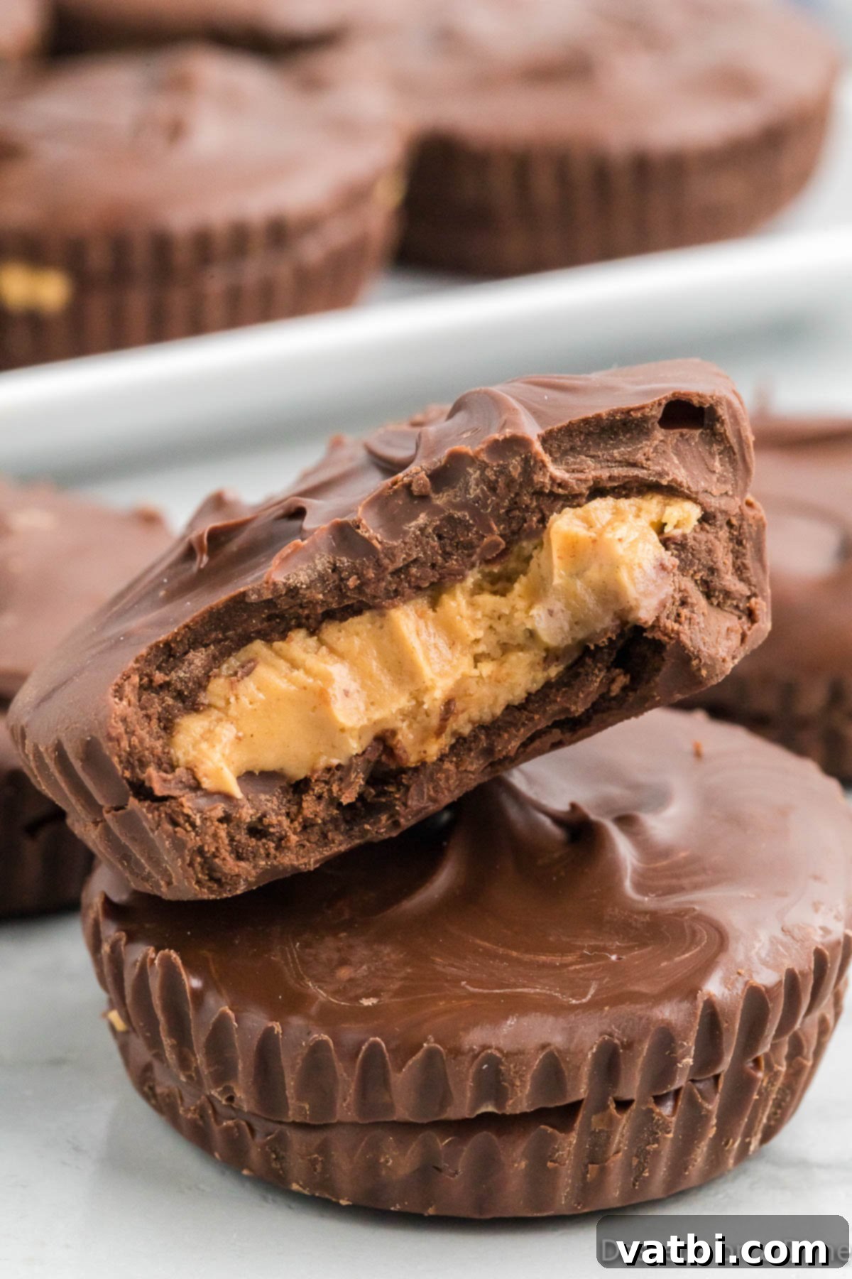 Decadent Homemade Peanut Butter Cups 2 Stack of homemade chocolate peanut butter cups, showing the perfect layers of chocolate and peanut butter filling.