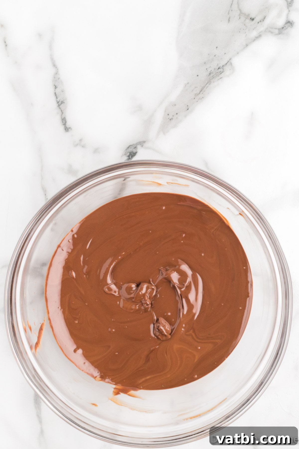 Decadent Homemade Peanut Butter Cups 6 Perfectly melted chocolate mixture in a bowl, smooth, glossy, and ready to be poured.