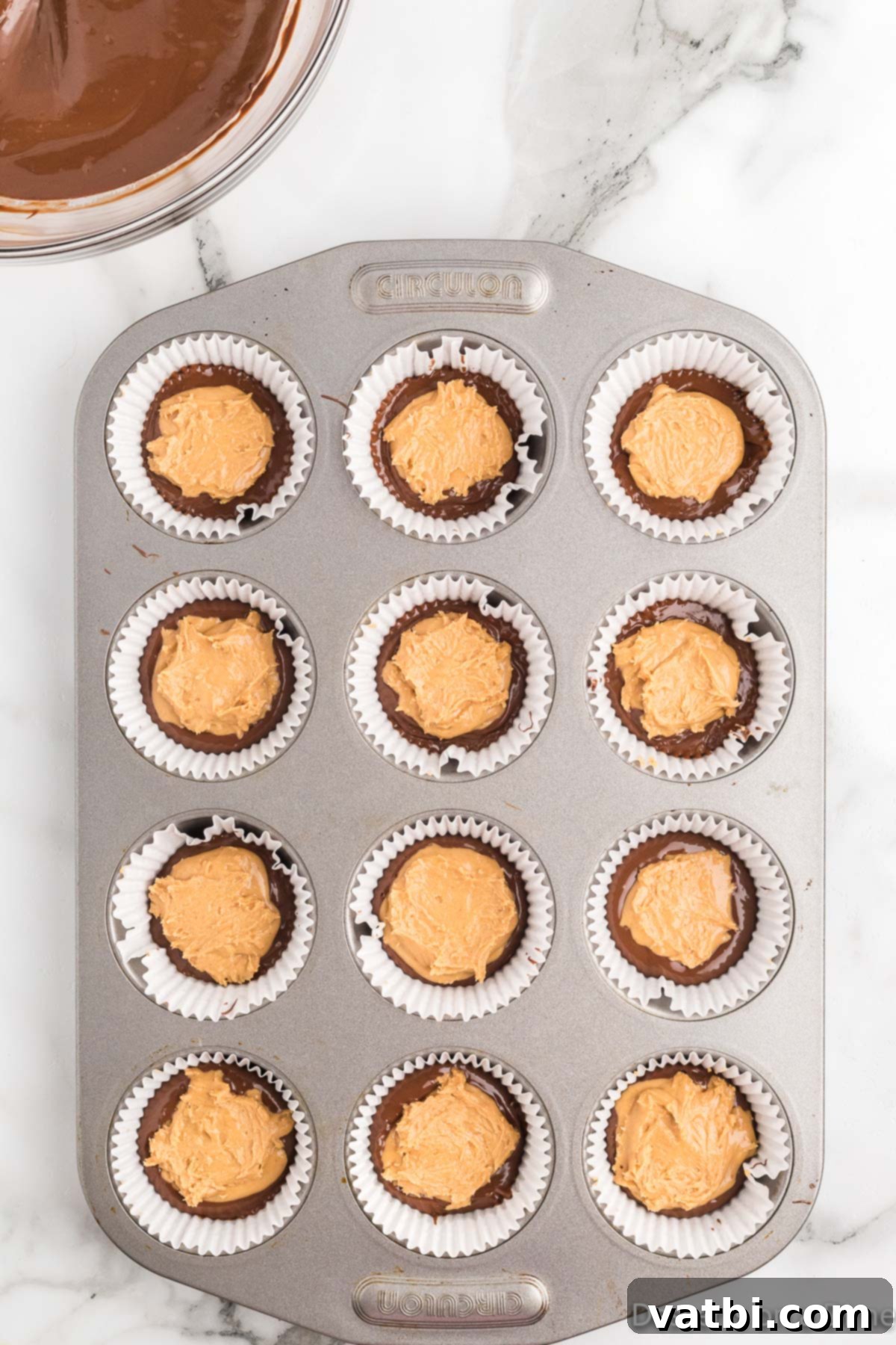 Decadent Homemade Peanut Butter Cups 8 Peanut butter filling scooped and gently pressed on top of the first chocolate layer in each cupcake liner.