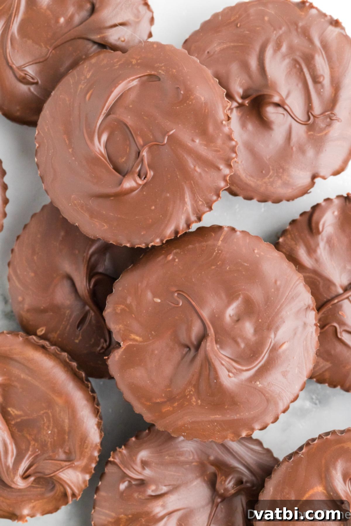 Decadent Homemade Peanut Butter Cups 9 A stack of perfectly formed homemade chocolate peanut butter cups, showcasing their delicious layers and ready to be enjoyed.
