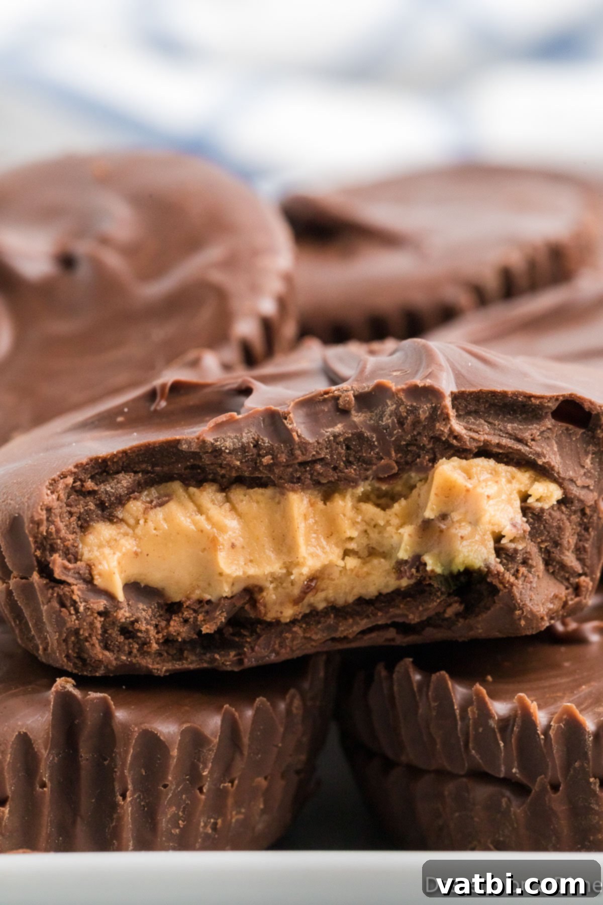 Decadent Homemade Peanut Butter Cups 10 A beautifully arranged stack of finished homemade chocolate peanut butter cups on a rustic wooden surface, highlighting their homemade charm.
