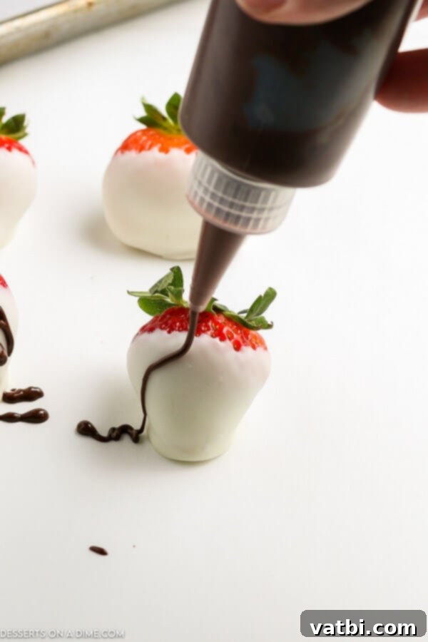Decadent Strawberry Delights 4 Close-up of chocolate covered strawberries with white chocolate drizzle and sprinkles.