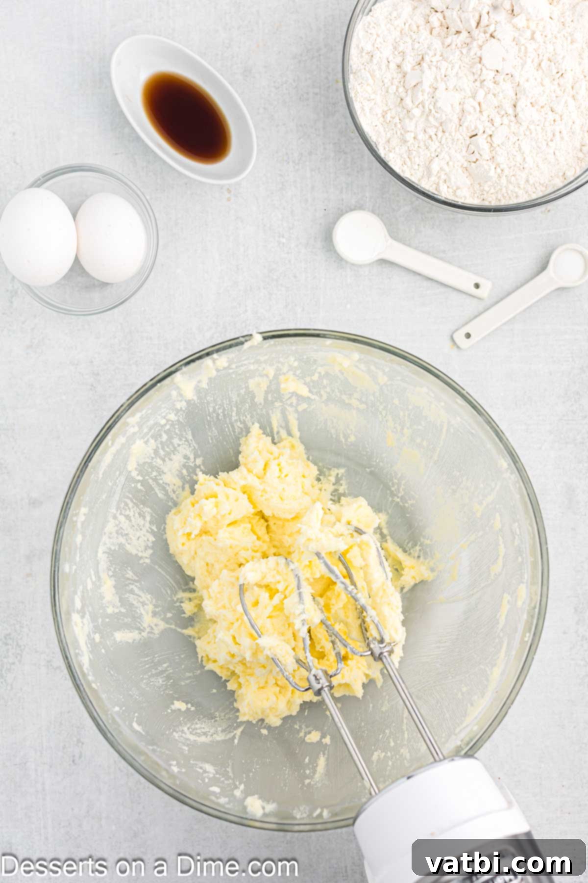 Sweet Clover Delights 4 Softened butter being creamed with granulated sugar in a large mixing bowl, showing a smooth and fluffy texture.