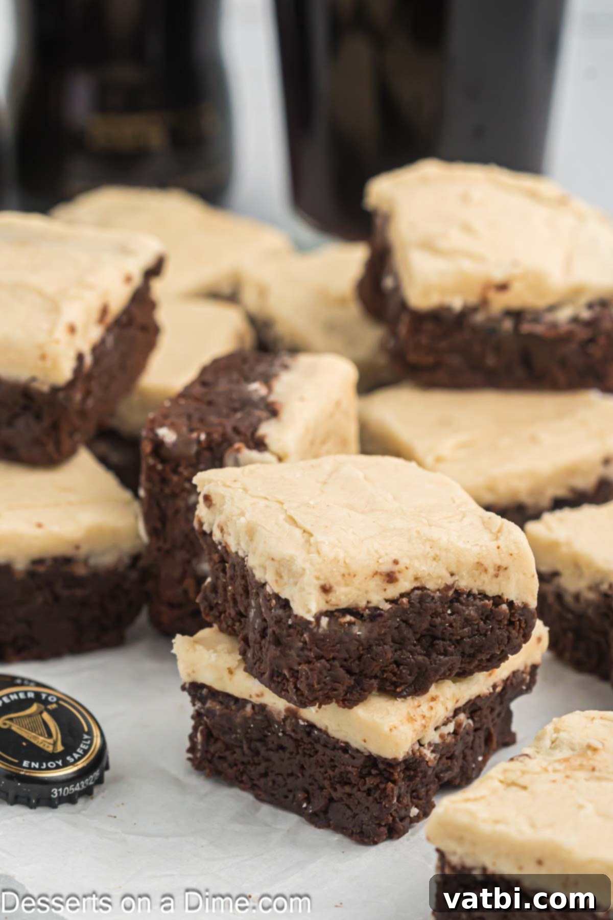 Rich Guinness Chocolate Brownies 13 A stack of perfectly cut, fudgy Guinness brownie bars with frosting, showing their appealing texture.