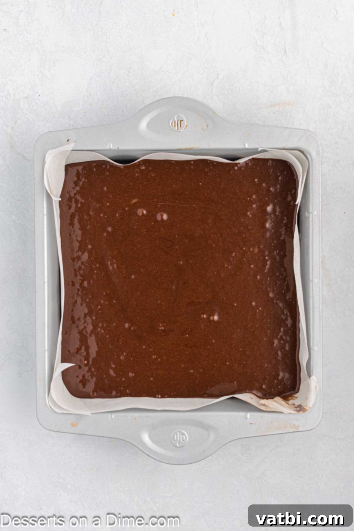 Rich Guinness Chocolate Brownies 6 Brownie batter being poured into the prepared 9x9 inch baking pan, ready for the oven.