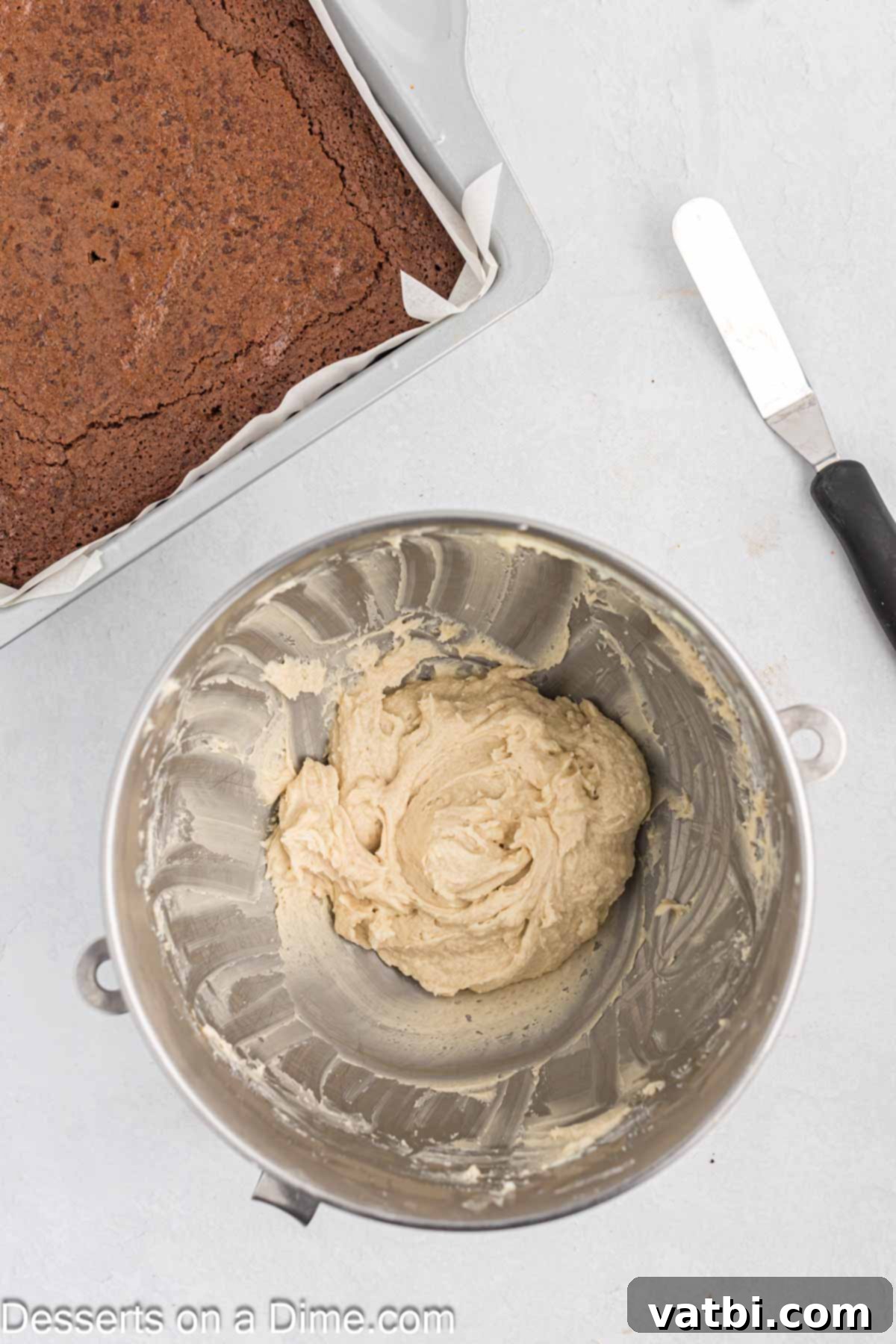 Rich Guinness Chocolate Brownies 9 Powdered sugar being gradually added to the beaten butter mixture in a stand mixer.