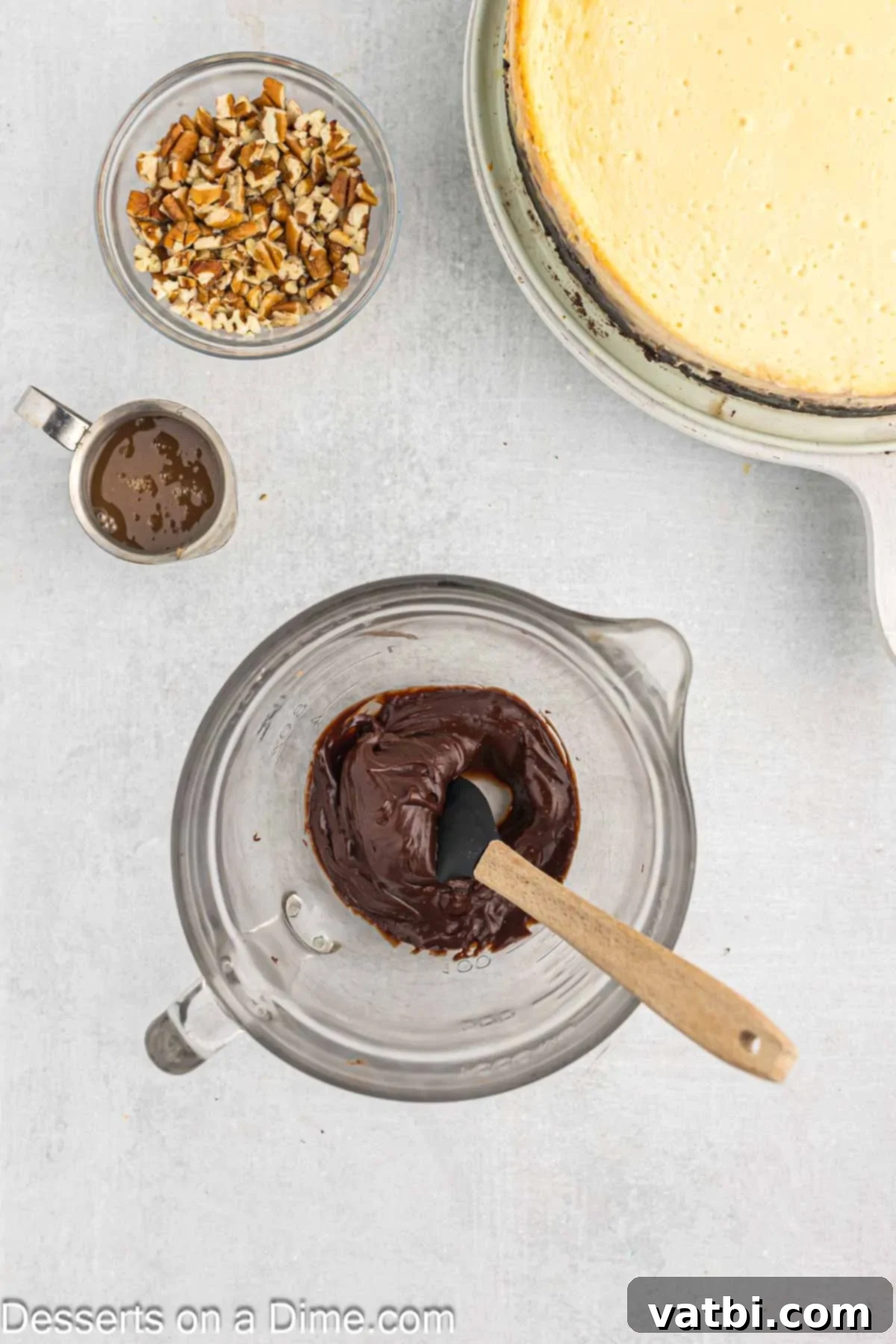 Turtle Cheesecake 11 Heavy cream and semi-sweet chocolate chips in a glass measuring cup, waiting to be combined to create a smooth chocolate drizzle for the cheesecake topping.