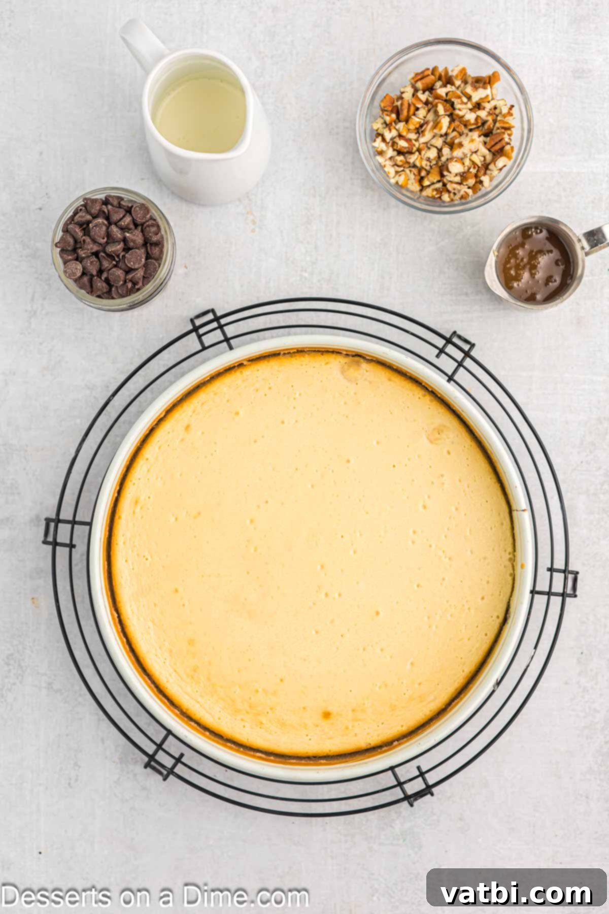 Turtle Cheesecake 10 A freshly baked Turtle Cheesecake cooling completely on a wire rack at room temperature after its time in the oven.