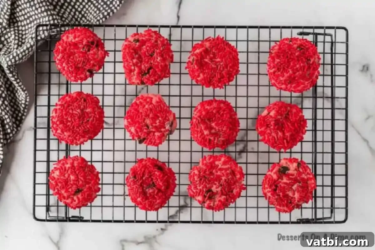 Chocolate Chip Strawberry Delights 7 Warm strawberry chocolate chip cookies, freshly baked and vibrant, arranged on a wire cooling rack to achieve the perfect texture.