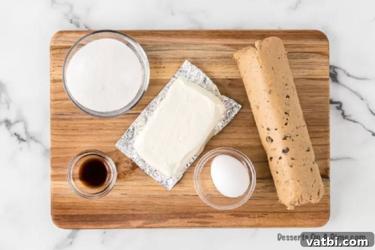Ingredients for chocolate chip cheesecake bars including chocolate chip cookie dough, cream cheese, sugar, egg, and vanilla extract.