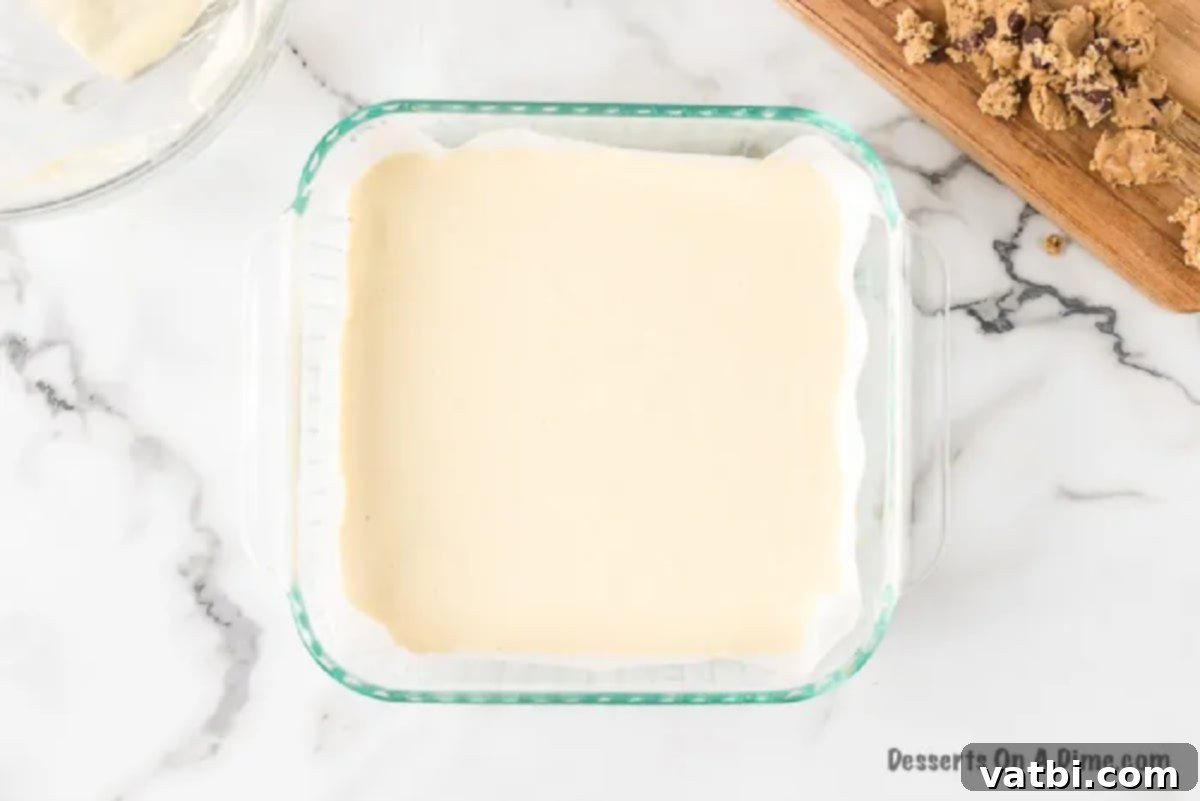 Cheesecake mixture spread evenly over the cookie crust in the baking pan.