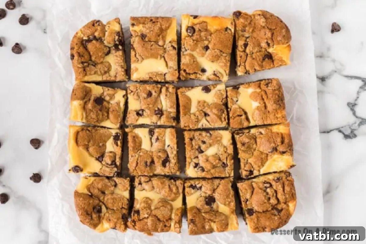 Chocolate chip cheesecake bars, cooled and cut into neat squares, ready for serving.
