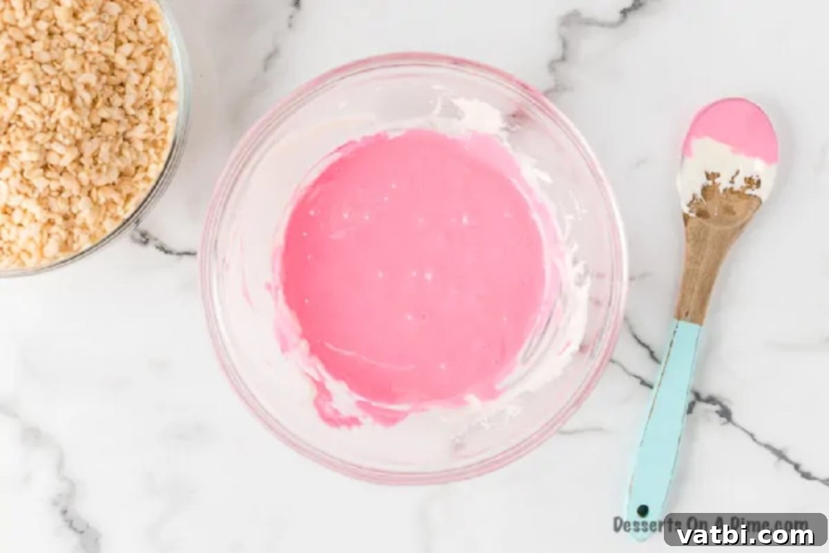 Colorful Easter Krispie Eggs 3 Melted marshmallow and butter mixture with pink food coloring being stirred in