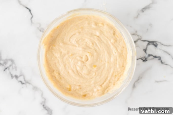 The finished banana cake batter is combined and ready for baking, showing its smooth texture.