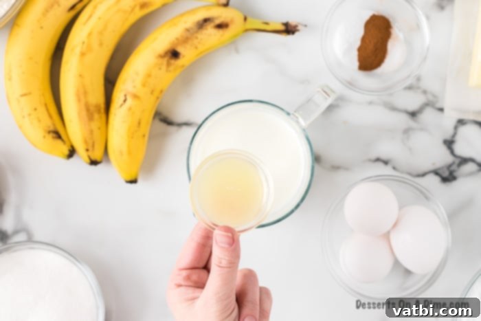 Milk and lemon juice are combined in a small bowl, beginning to curdle slightly.