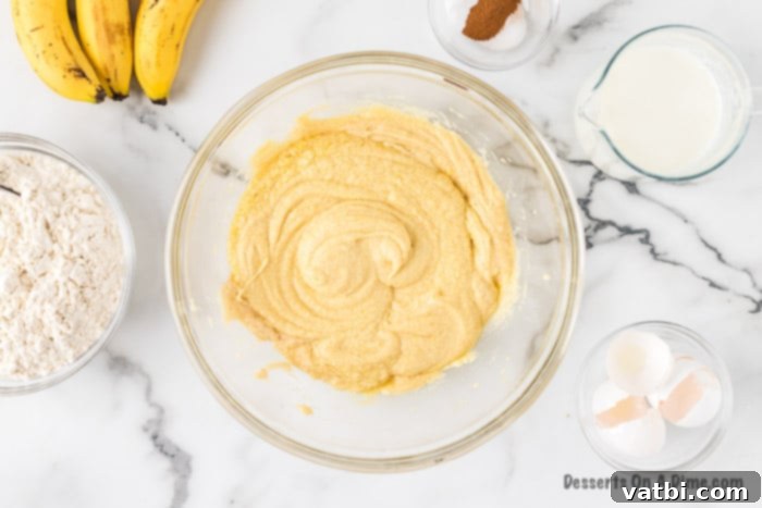 The butter, sugar, and egg mixture is smooth and pale in the mixing bowl after being combined.