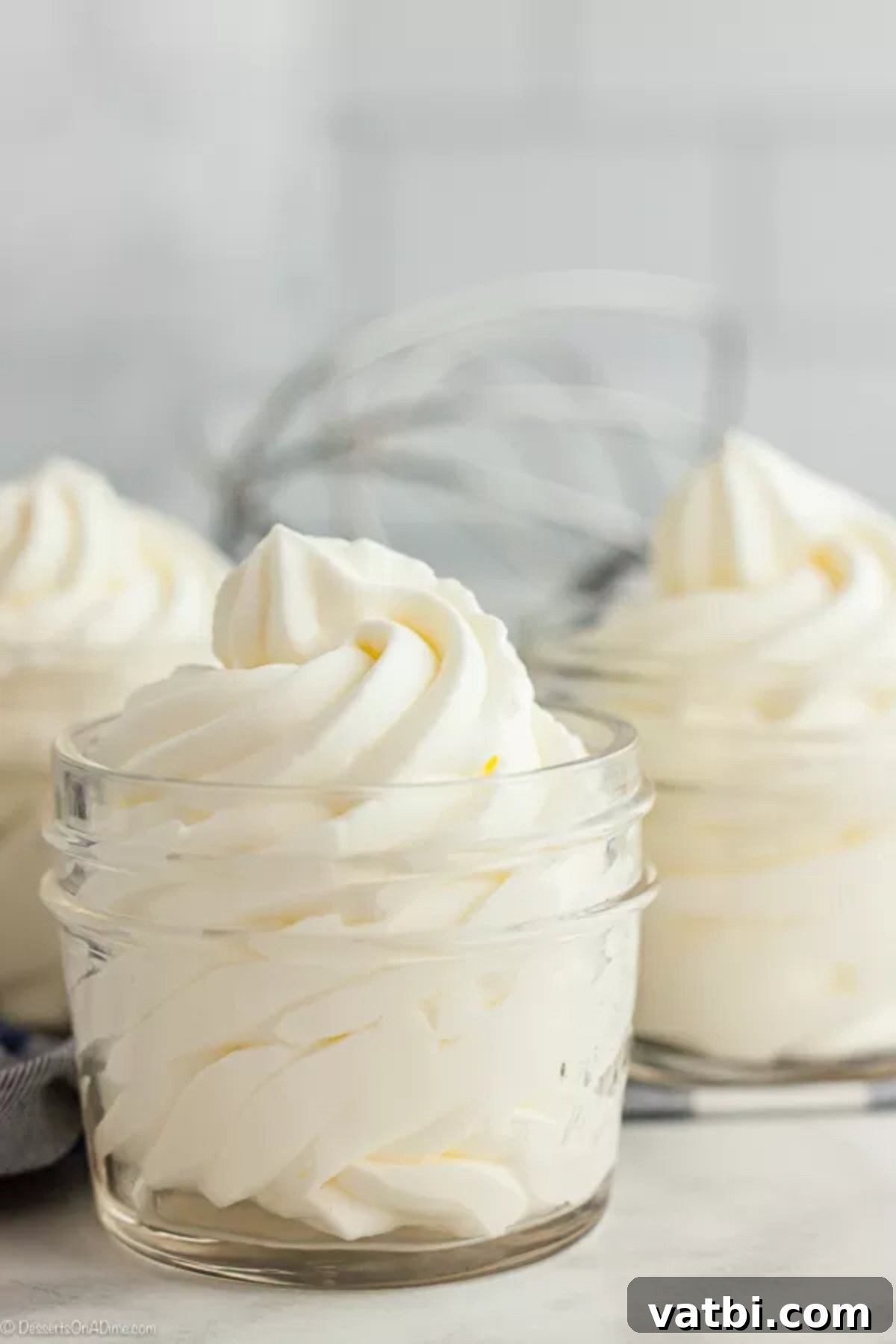 Once you try this Homemade Whipped Cream Recipe, you will never buy store bought whipped cream. This whipped cream recipes is easy with just 2 ingredients and tastes amazing. Try this heavy whipping cream recipes today. You will love this fresh whipped cream recipe! #dessertsonadime #whippedcream Homemade whipped cream in 3 small mason jars.