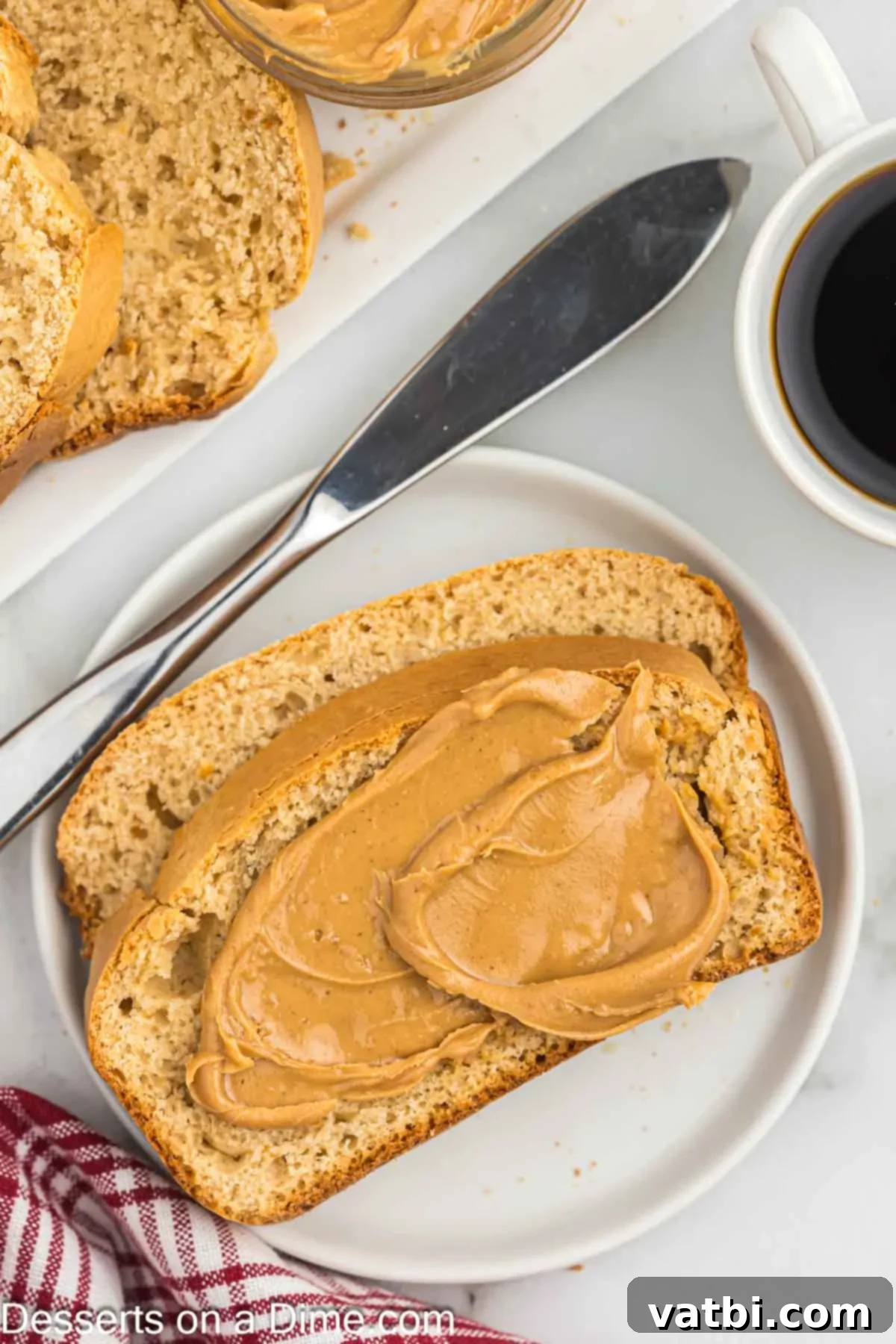 Slice of peanut butter bread with peanut butter spread on it, ready to be enjoyed as a snack or breakfast.