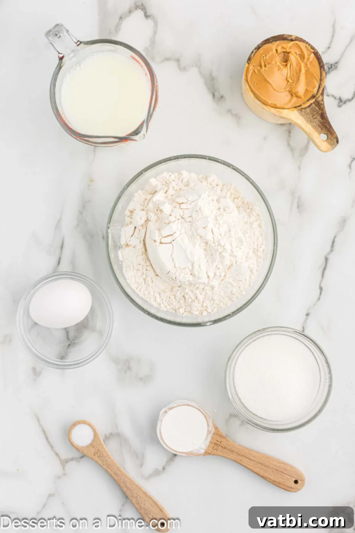 Ingredients for making peanut butter bread: flour, sugar, egg, baking powder, salt, milk, and creamy peanut butter.