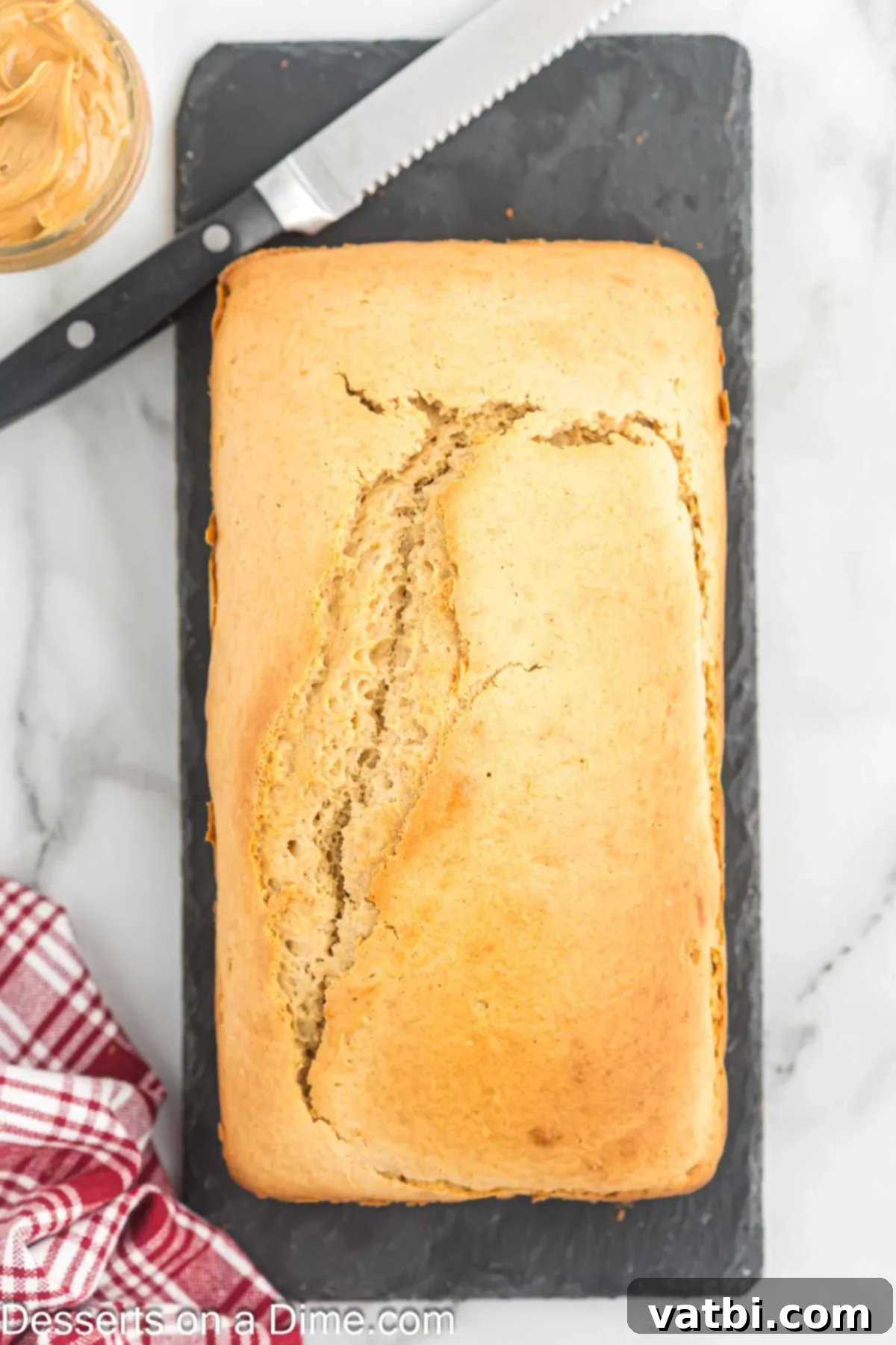 Freshly baked peanut butter bread cooling on a wire rack.