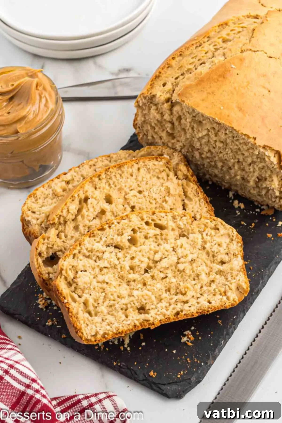 Slices of baked peanut butter bread arranged on a plate, ready to be served.