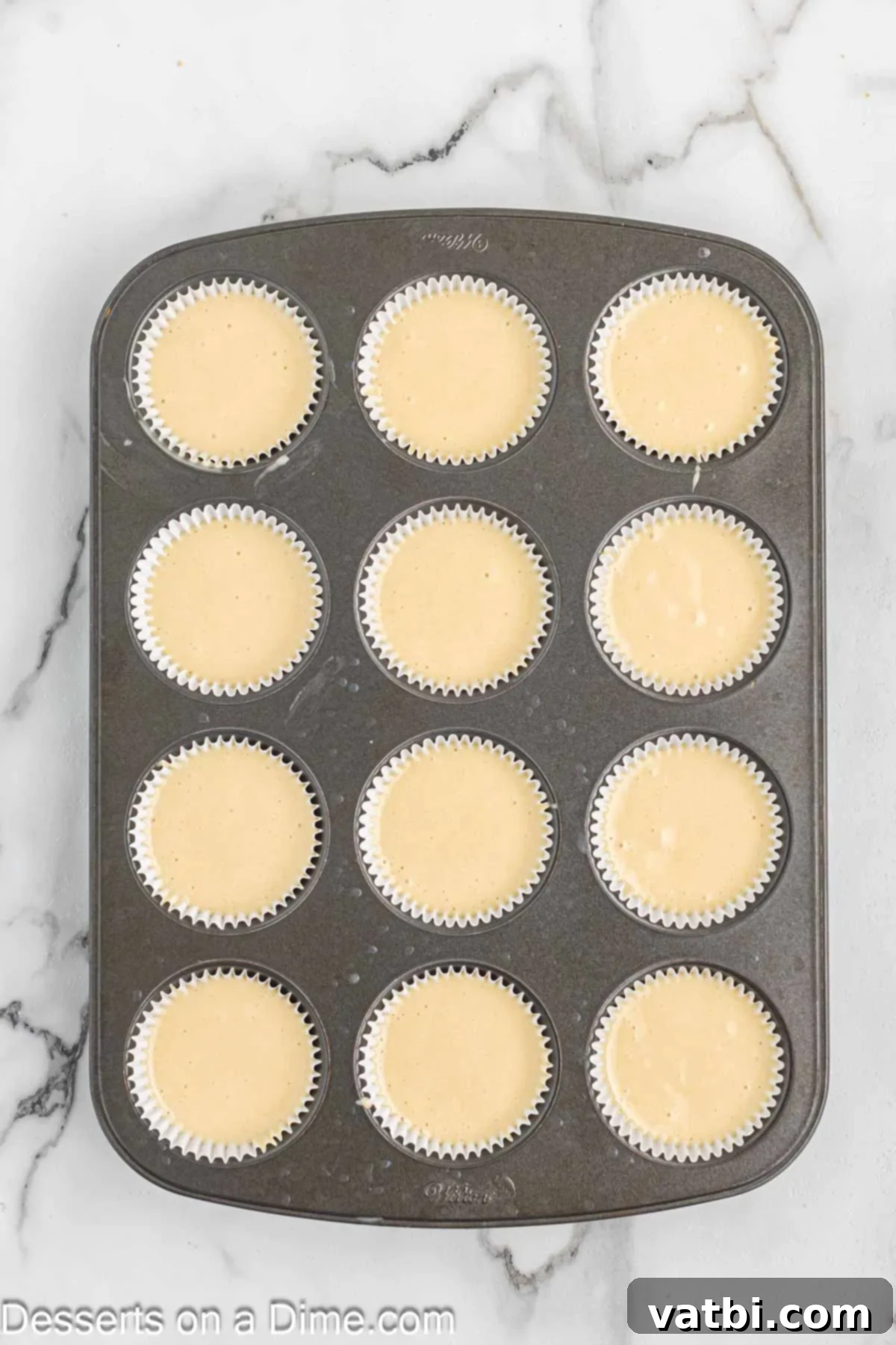 Heavenly Strawberry Shortcake Cupcakes 6 Cupcake batter poured into muffin tins, ready for baking.