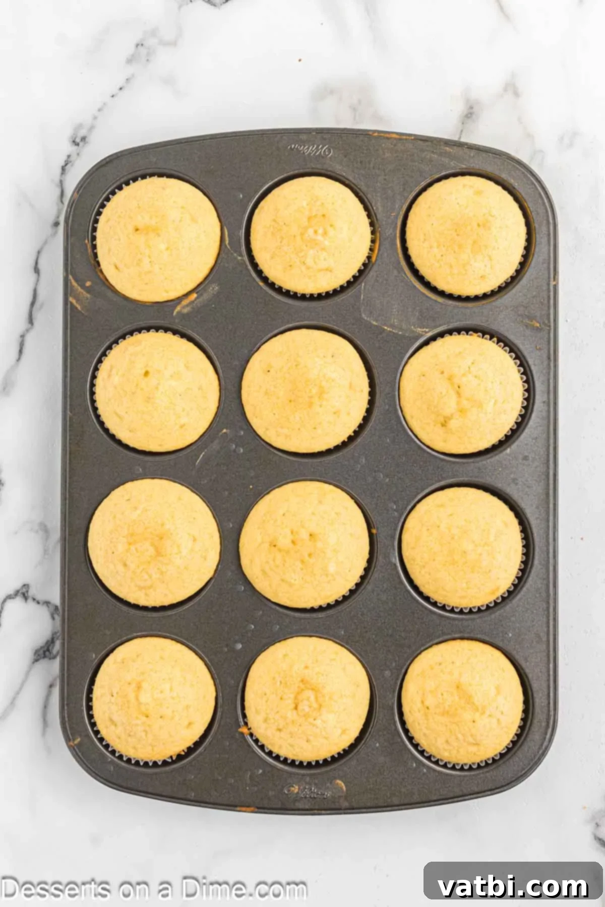 Heavenly Strawberry Shortcake Cupcakes 7 Baked cupcakes cooling in the muffin pan after being removed from the oven.