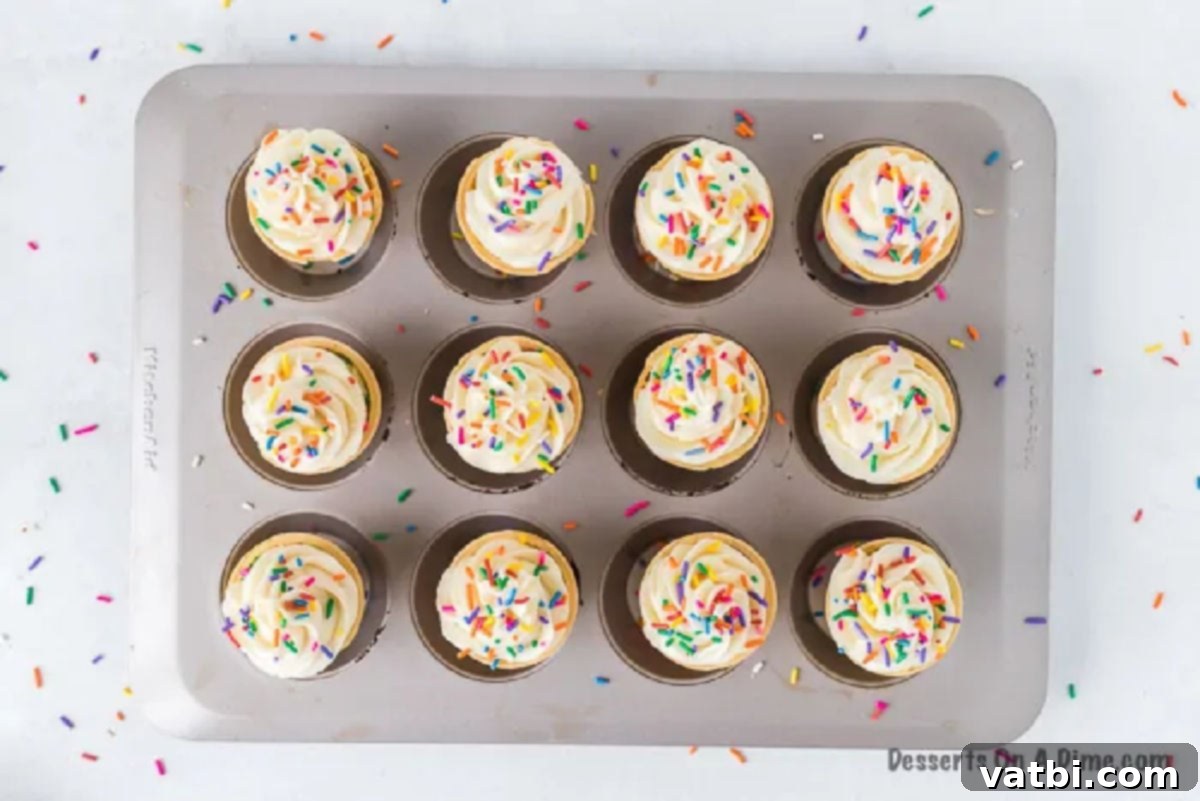 Sweet Cone Treats 5 Cupcakes topped with icing and sprinkles.