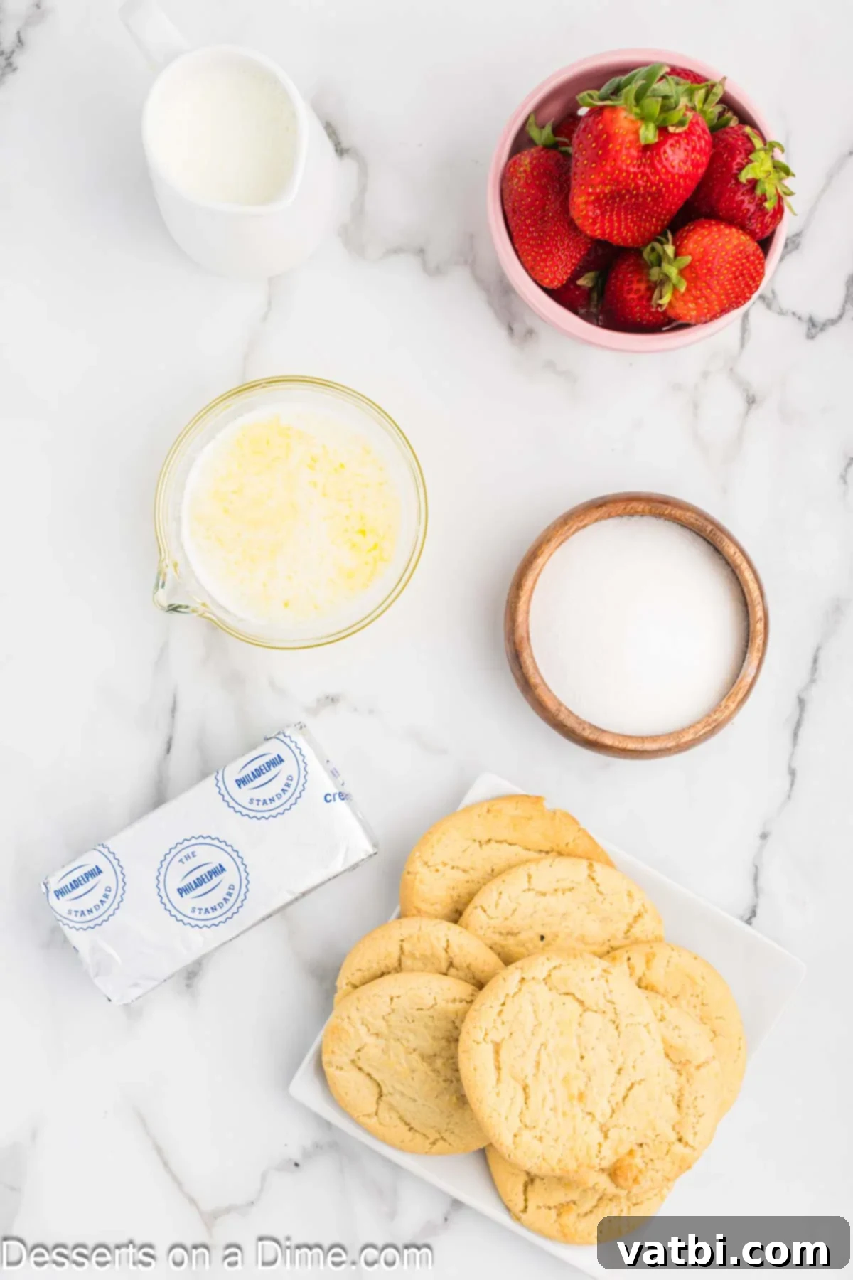 Easy Strawberry Crunch Bars 3 All ingredients for Strawberry Crunch Bars neatly arranged: a stack of sugar cookies, granulated sugar, a stick of butter, a block of cream cheese, a carton of heavy cream, and fresh strawberries.