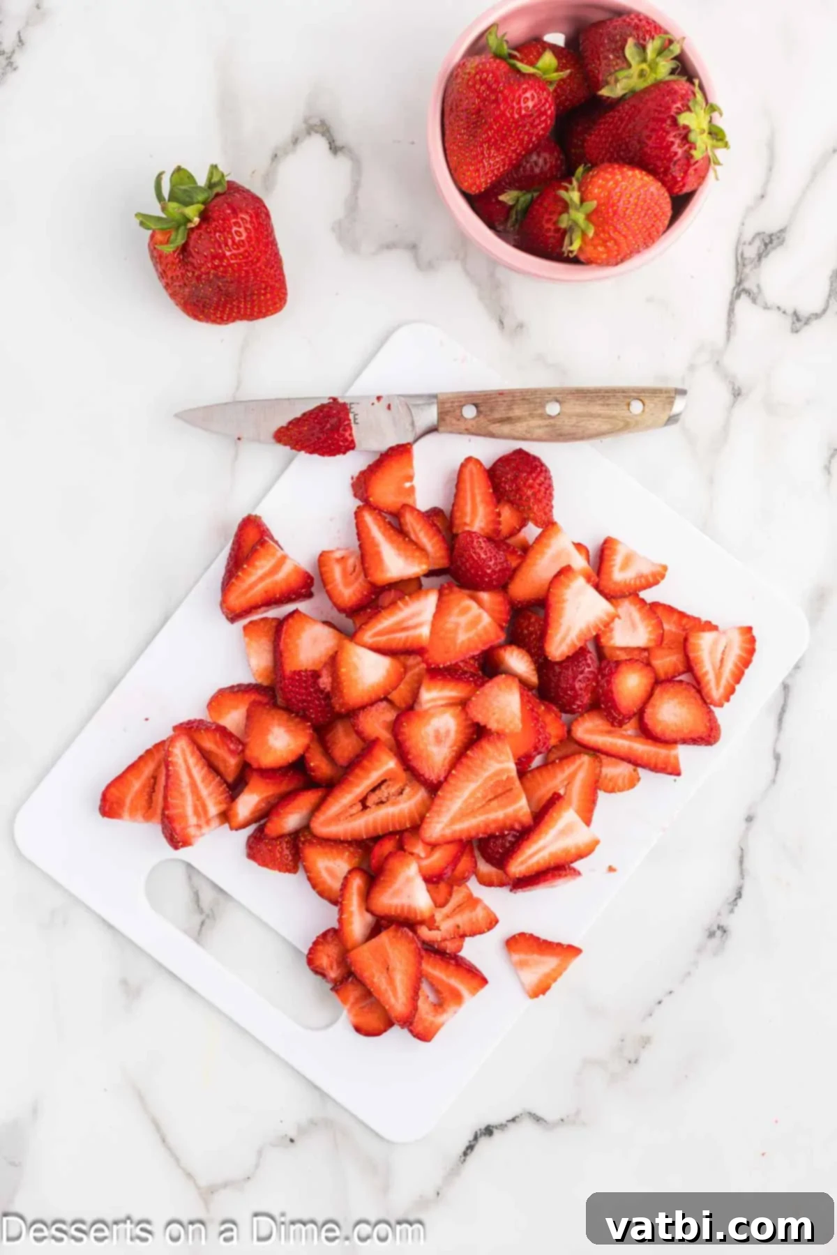 Easy Strawberry Crunch Bars 7 Fresh strawberries sliced on a cutting board.