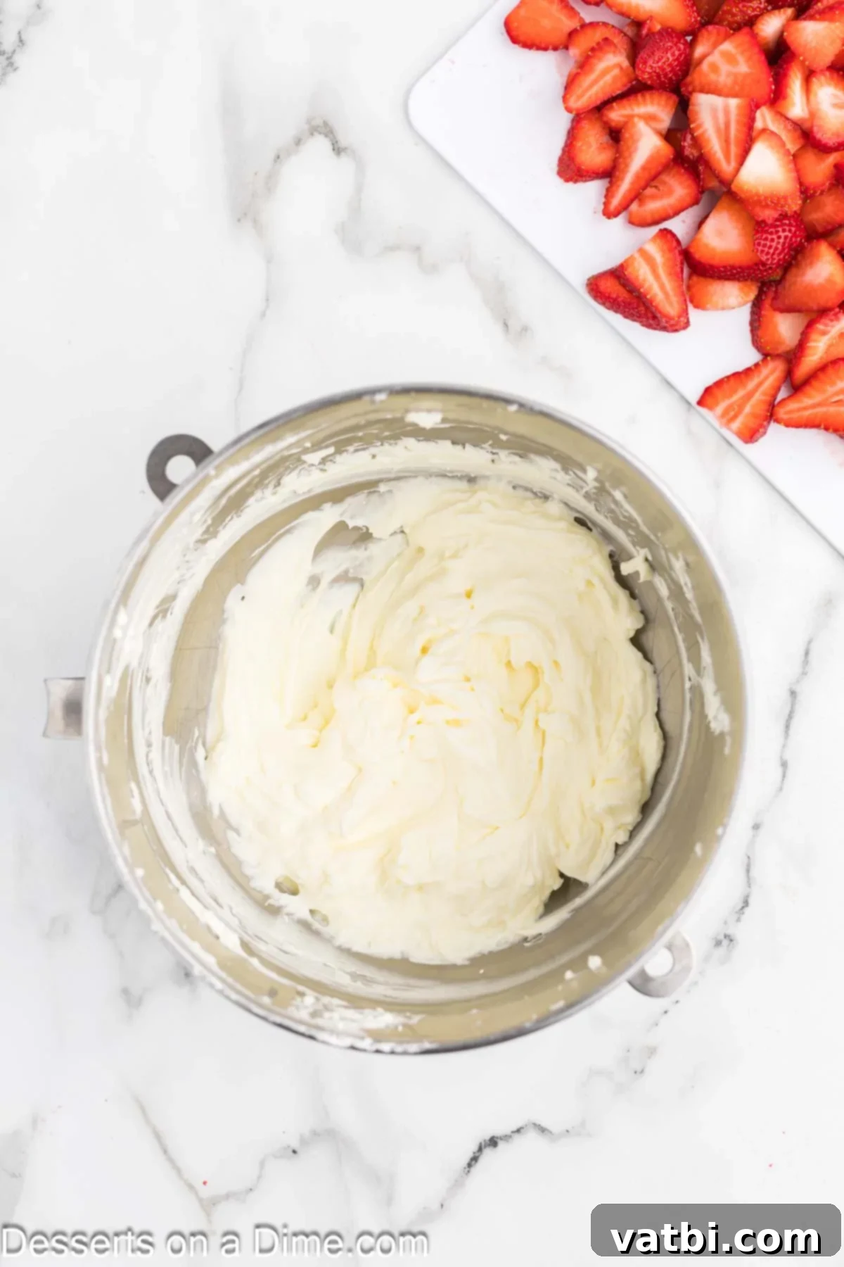 Easy Strawberry Crunch Bars 8 Whipped cream and softened cream cheese being combined in a bowl.