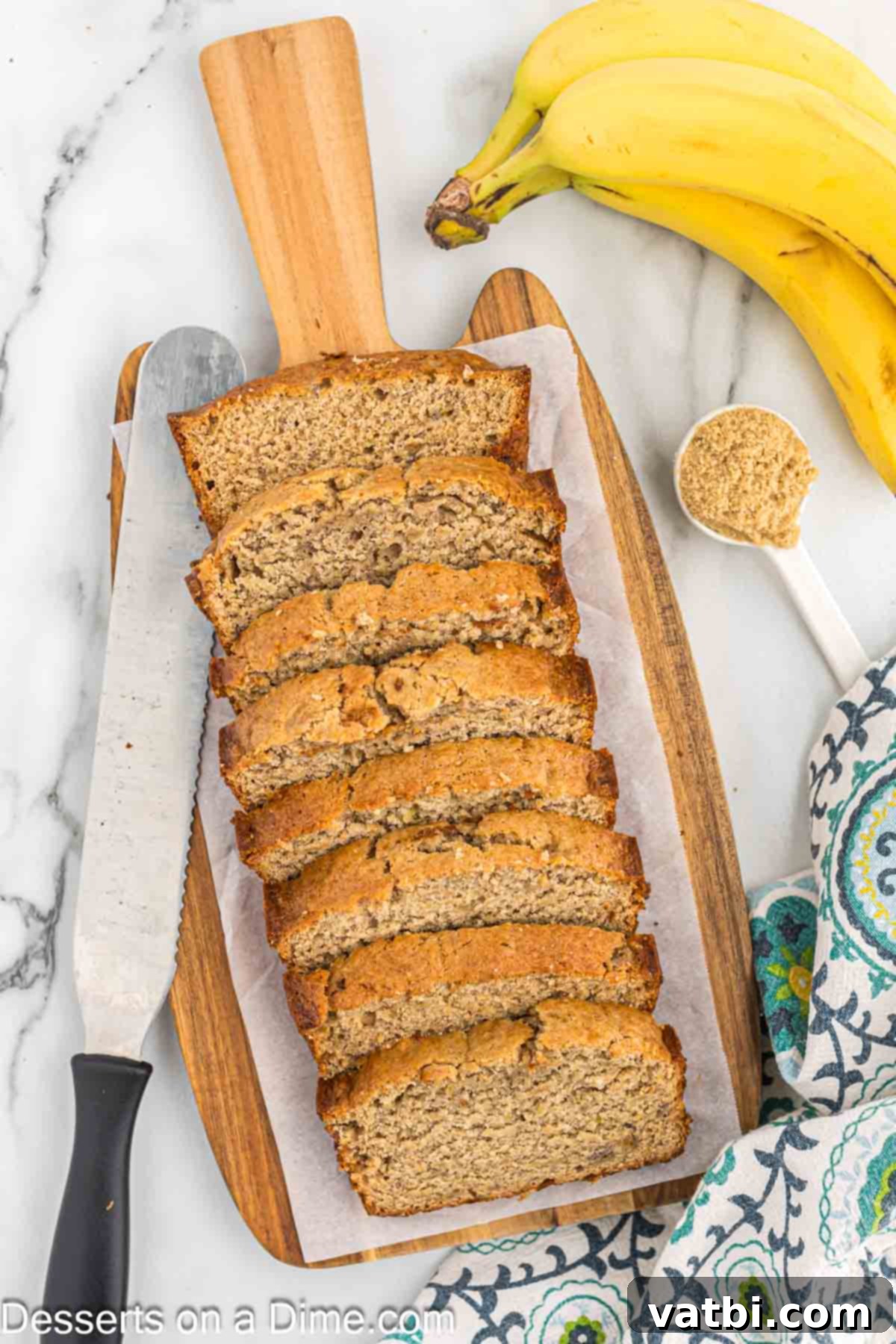 Brown Sugar Banana Bread 2 Loaf of banana bread sliced on cutting board.