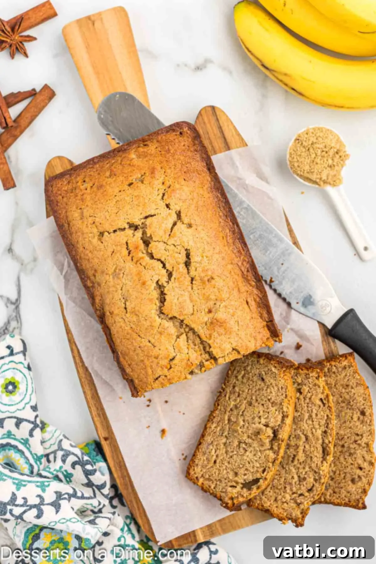 Brown Sugar Banana Bread 9 Bread being sliced on cutting board.