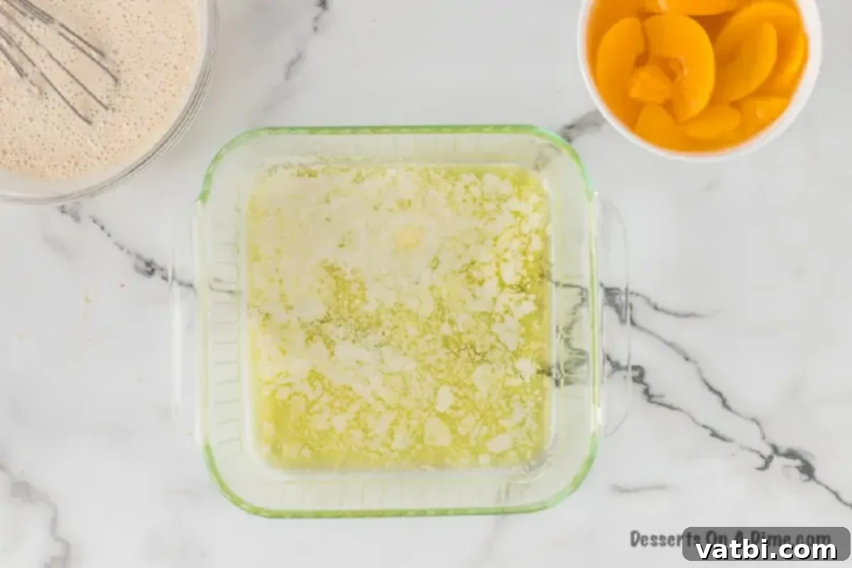 Deliciously Simple Peach Cobbler 4 Melted butter coating the bottom of a baking dish, spread evenly for the cobbler.