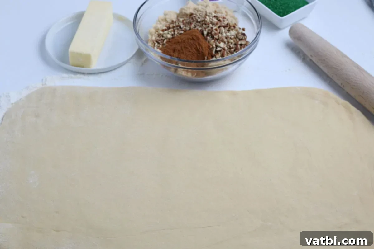 Homemade Mardi Gras King Cake 6 Dough rolled out flat into a large rectangle.