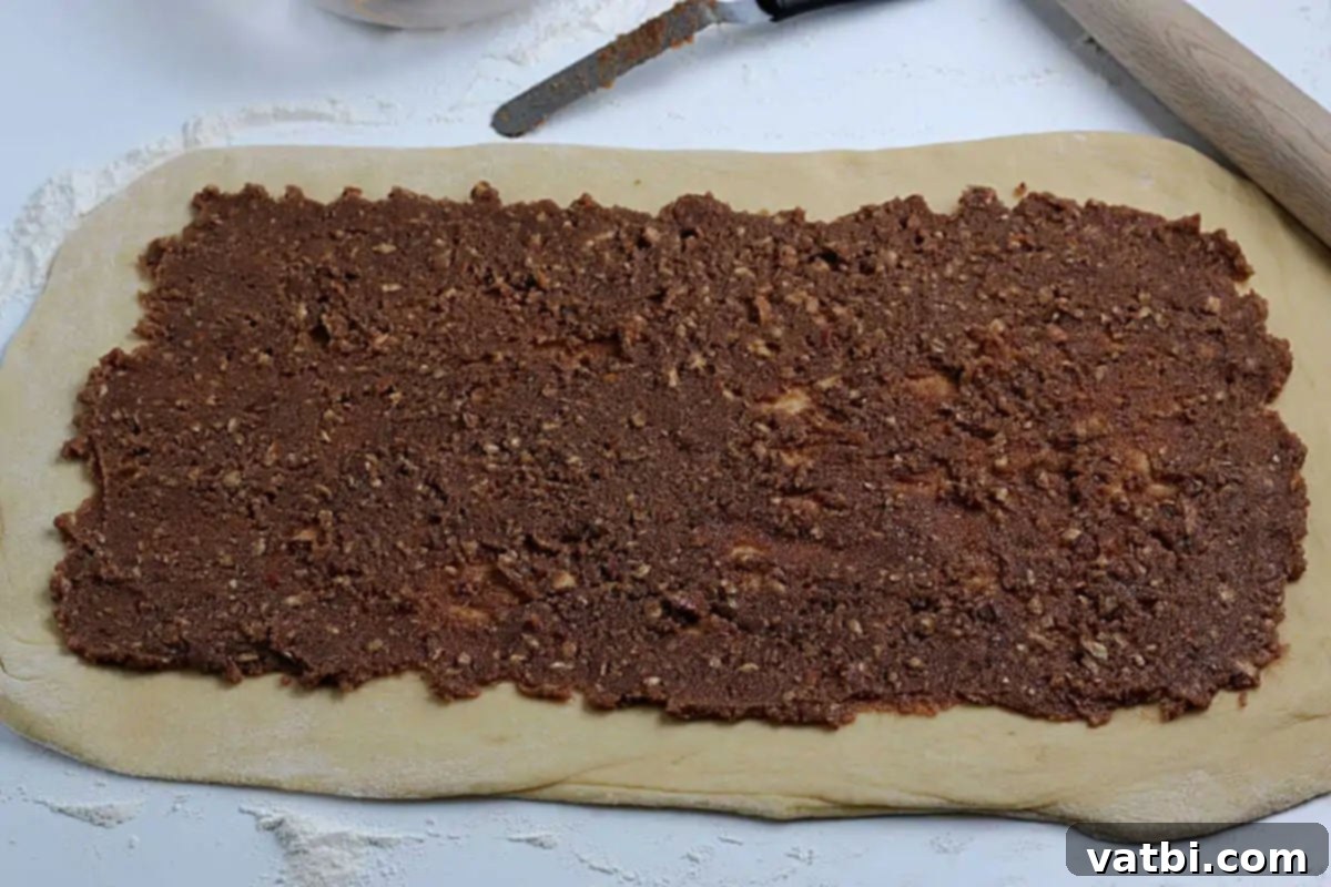 Homemade Mardi Gras King Cake 7 Cinnamon sugar mixture spread evenly on the rolled-out dough.