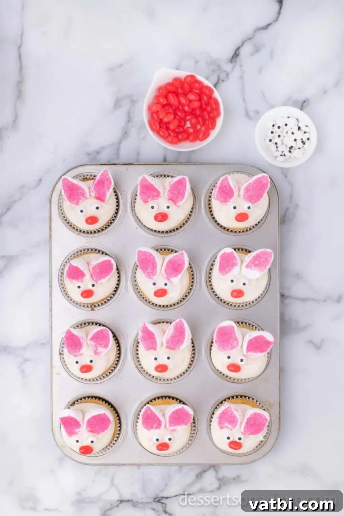 Finished Easter Bunny Cupcakes decorated with marshmallow ears, candy eyes, and jelly bean noses, arranged on a serving platter.